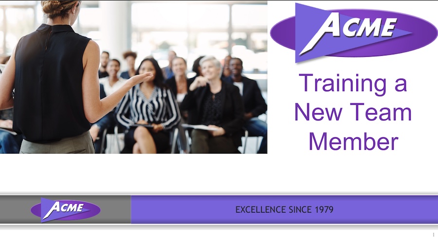 An instructor standing in front of participants to the left of a logo and course title, above a gray and purple bar